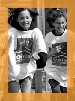 Two girls from Girls on the Run sprinting.